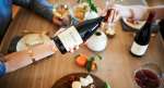 Passing a bottle of Sea View Ridge Pinot Noir